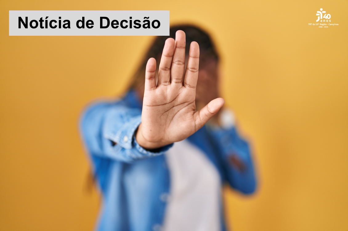foto de fundo laranja com uma mulher de camisa jeans e mão direita estendida, escondendo seu rosto